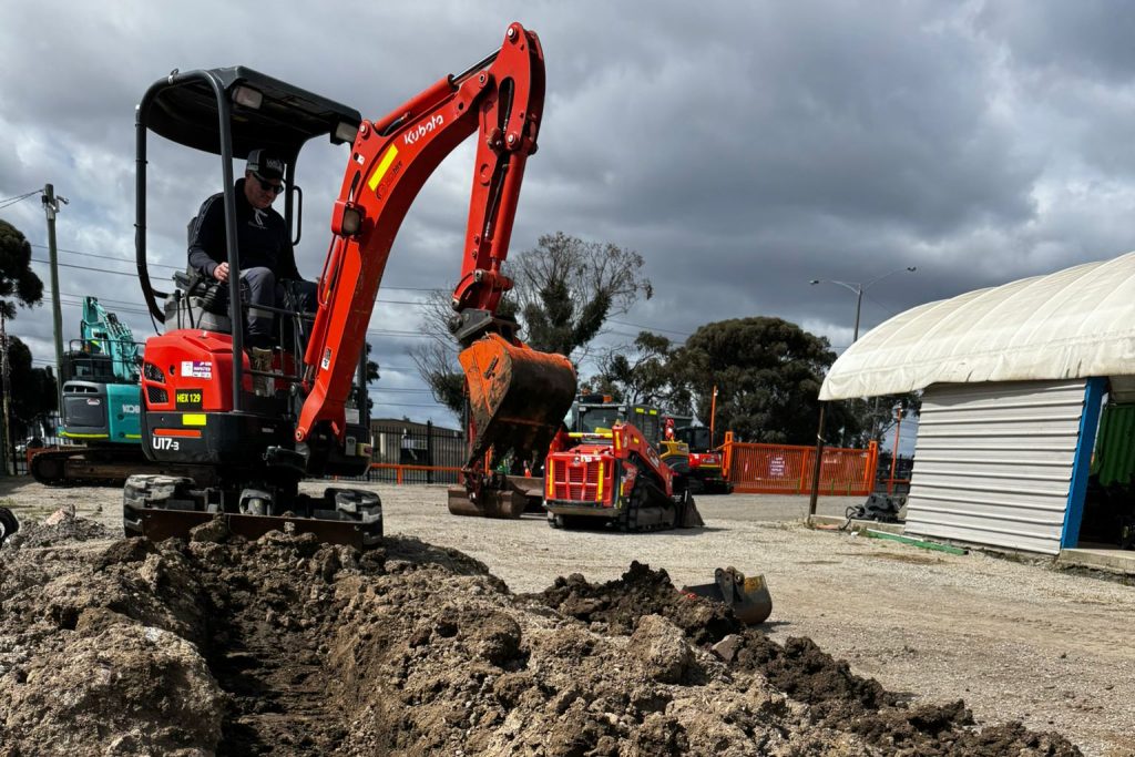 Excavator on site digging out trench for drainage.